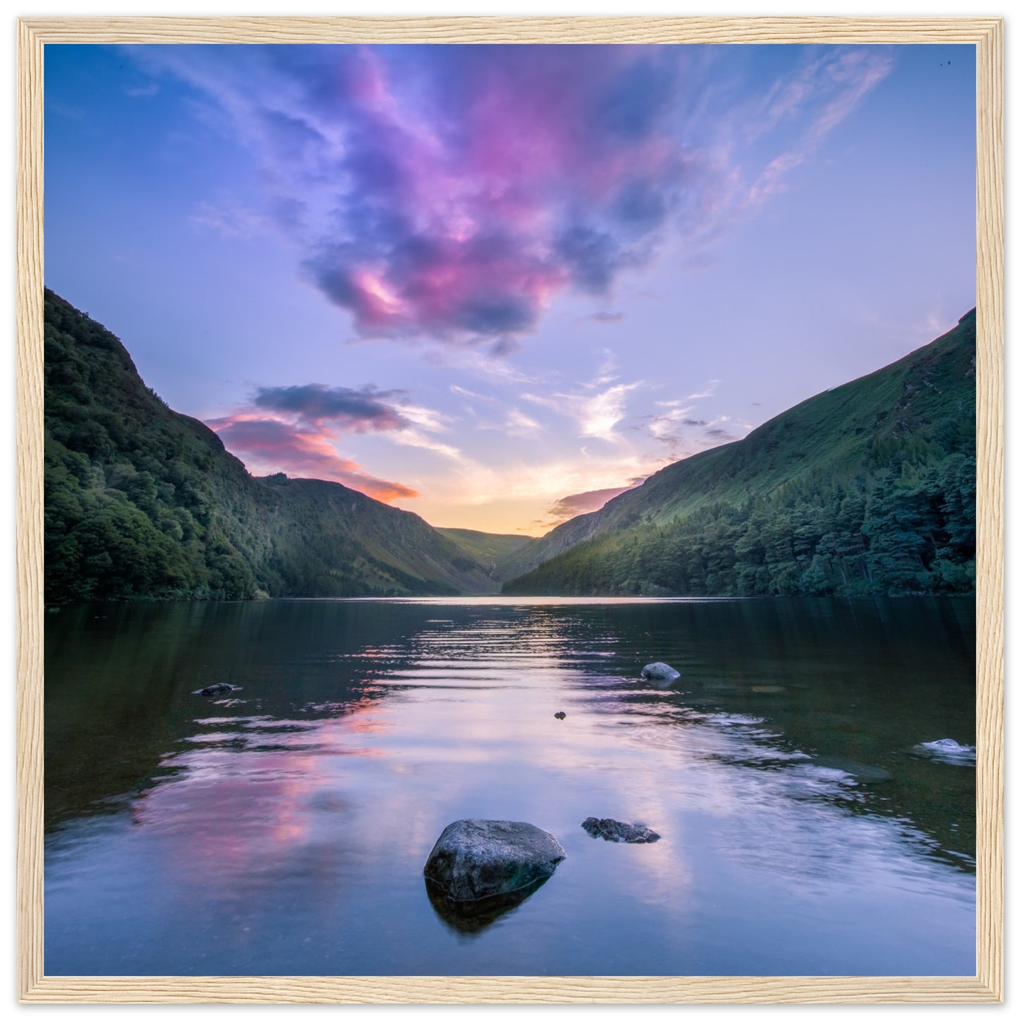 Framed wall art print of Glendalough Valley, featuring the Upper Lake at dusk with serene sky reflections,
in a wooden frame.