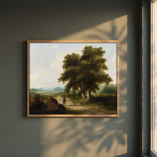 A Landscape, Homeward Bound framed print in a natural oak frame on a dark green wall beside a window, dappled plant shadow