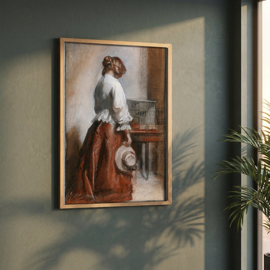 Lady with a Birdcage framed print in a natural oak frame on a dark green wall beside a window, dappled plant shadow
