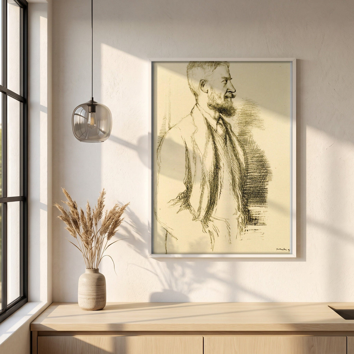 Mr George Bernard Shaw (1897) by William Rothenstein framed print in a white frame on a plaster wall above an oak worktop in a bright Scandinavian kitchen