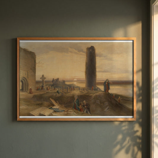 The Last Circuit of Pilgrims at Clonmacnoise by George Petrie framed print in a natural oak frame on a dark green wall beside a window, dappled plant shadow