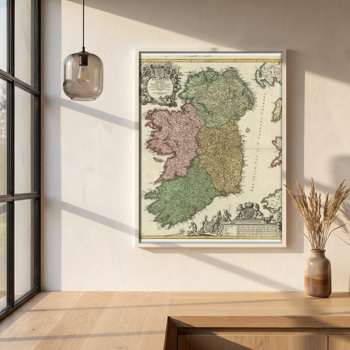 The Kingdom of Ireland map framed print in a white frame on a plaster wall above an oak worktop in a bright Scandinavian kitchen