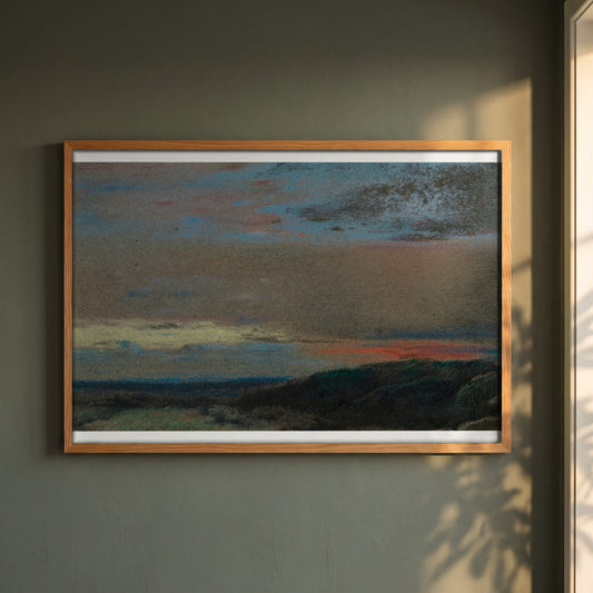 The Moor at Sunrise framed print in a natural oak frame on a dark green wall beside a window, dappled plant shadow