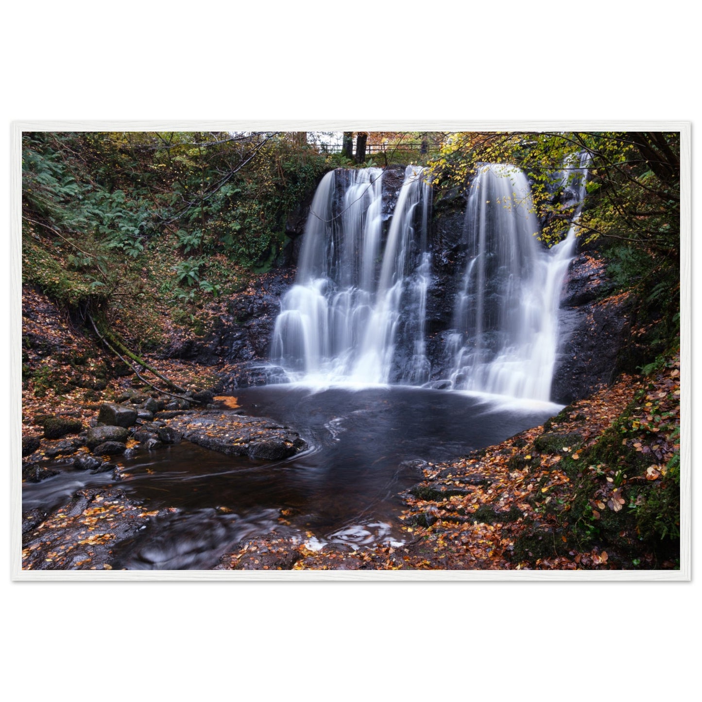 Framed print of Glenariff Waterfall, capturing the serene beauty of cascading water amidst lush greenery in the Glens of Antrim, Northern Ireland. Known as the 'Queen of the Glens,' this stunning landscape print brings nature's tranquility into your home.