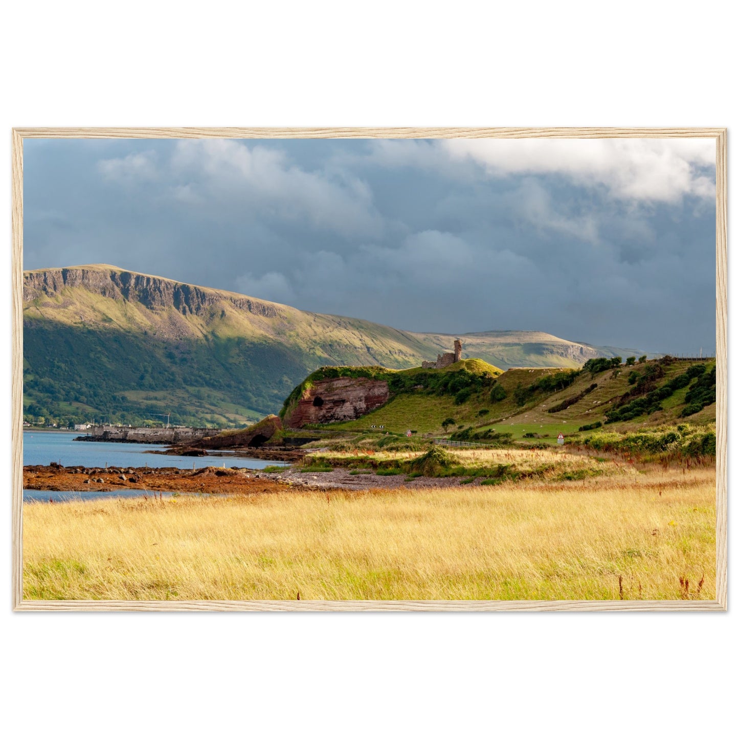 A framed print featuring Red Bay Castle amidst coastal cliffs, capturing the rugged beauty of County Antrim's Causeway Coastal Route. Historical charm meets natural grandeur in this stunning artwork.