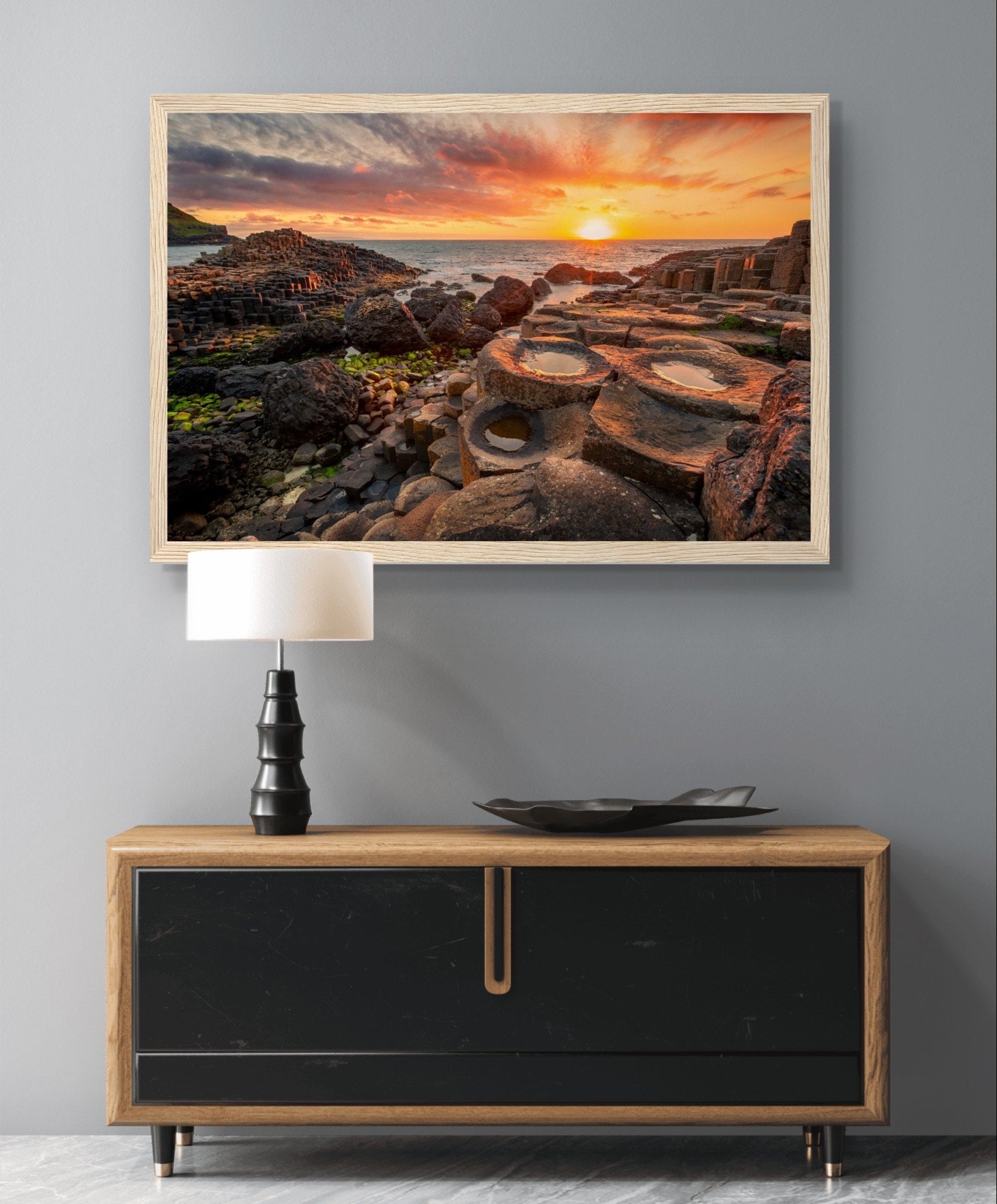 The framed design adds a touch of sophistication, making it a perfect addition to your home or office decor. Immerse yourself in the tranquility of this coastal landscape every day with our Sunset at Giant's Causeway framed art print