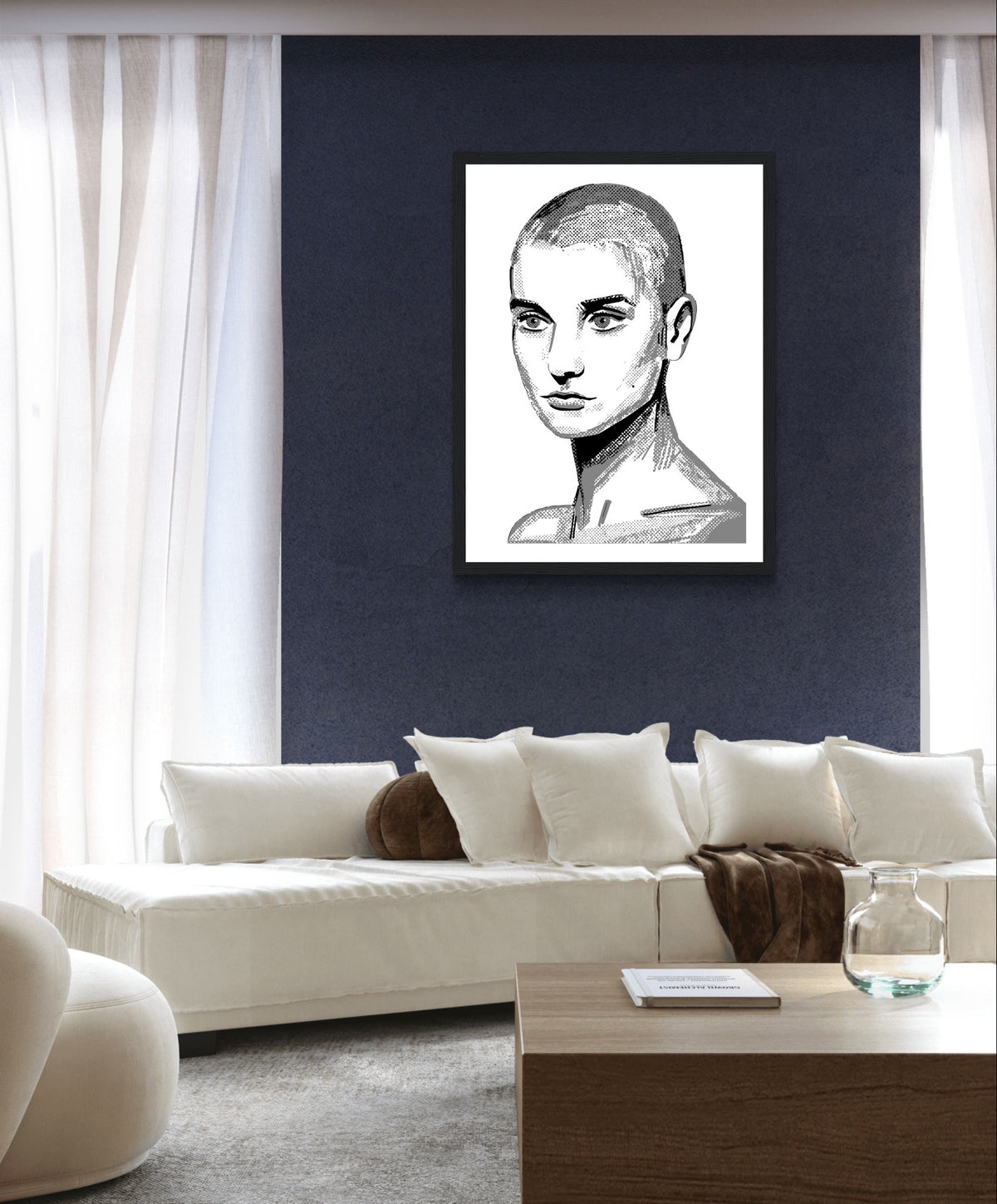 Sinéad O'Connor black and white line portrait print in a white frame on a navy wall above a white sofa