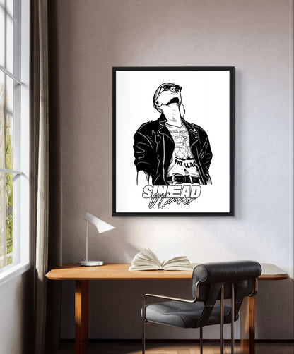 Black and white Sinéad O'Connor portrait print in a black frame above a desk by a window