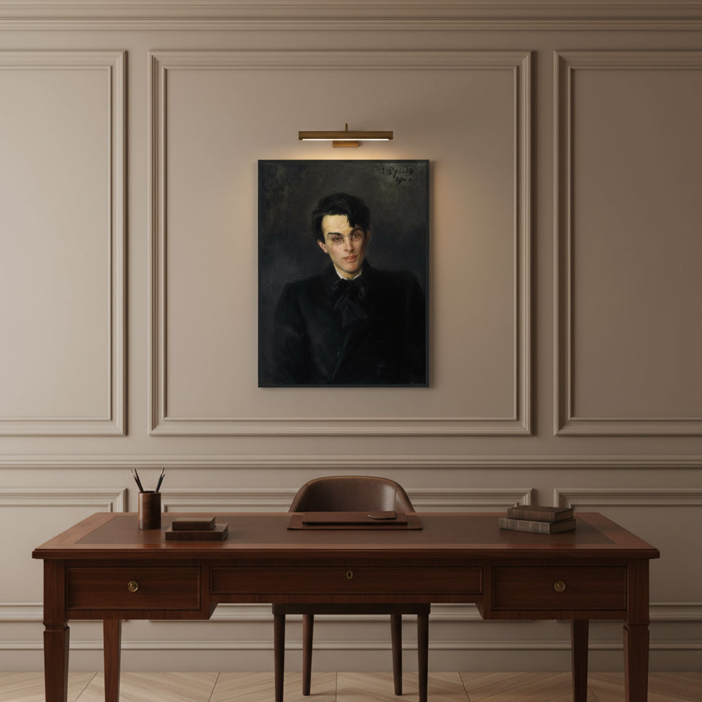 Classic study with wall mouldings, walnut desk and brass picture light; W. B. Yeats portrait in black frame centered above desk.