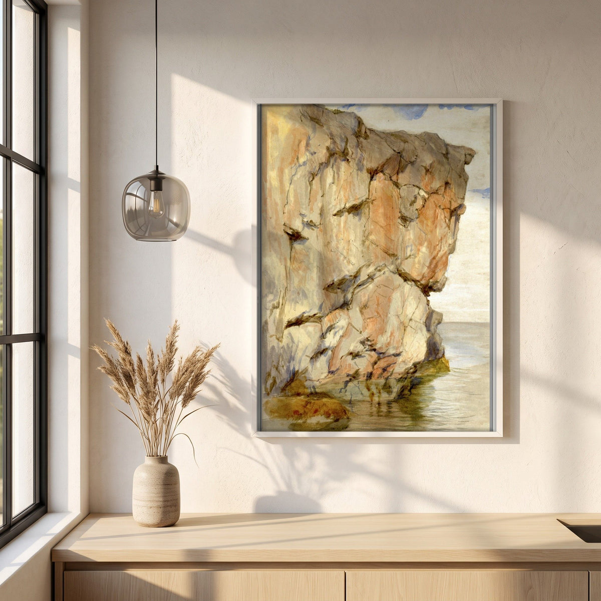 A Cliff at Howth, County Dublin framed print in a white frame on a plaster wall above an oak worktop in a bright Scandinavian kitchen