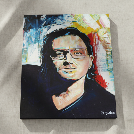 Bono U2 portrait print shown at an angle on a linen surface, bold blue, red and yellow brushwork