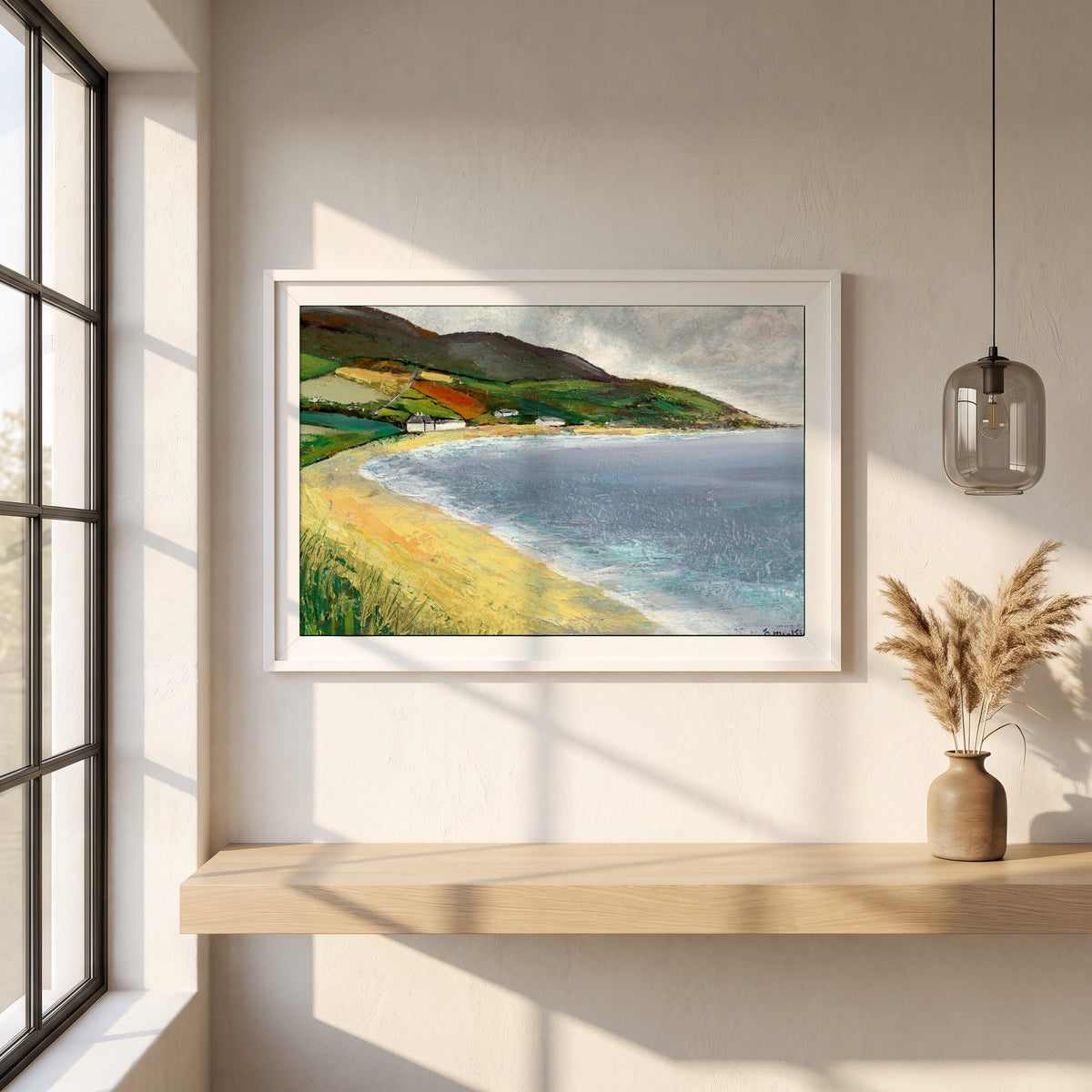 Cushendun Beach, County Antrim framed print in a white frame on a plaster wall above an oak worktop in a bright Scandinavian kitchen
