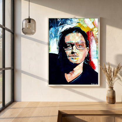 Vibrant Bono U2 framed print in a white frame on a plaster wall above an oak worktop in a bright Scandinavian kitchen