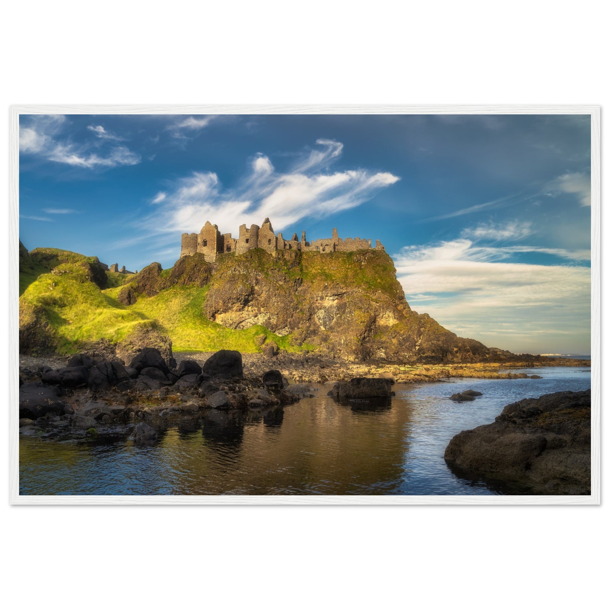 Framed wall art print of Dunluce Castle, showcasing its majestic ruins perched on a rugged cliff overlooking the sea. The detailed image captures the historic architecture and breathtaking coastal scenery, perfect for adding a touch of history and beauty to any room.