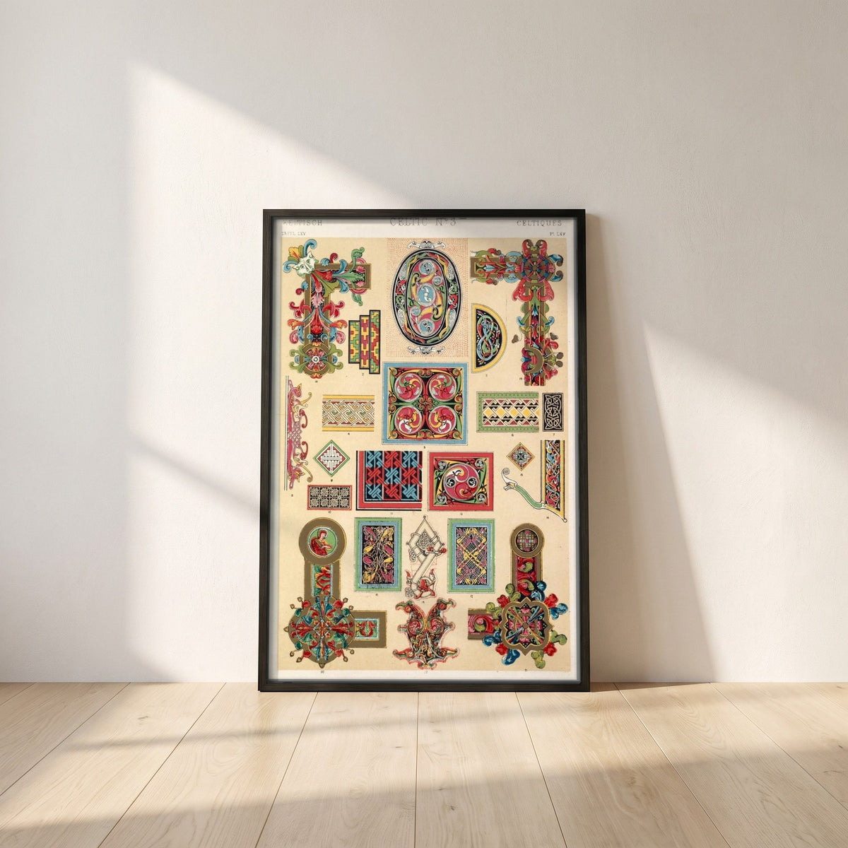 Celtic No.3 (1856) by Owen Jones framed print in a black frame leaning against a white plaster wall on oak floorboards in morning light