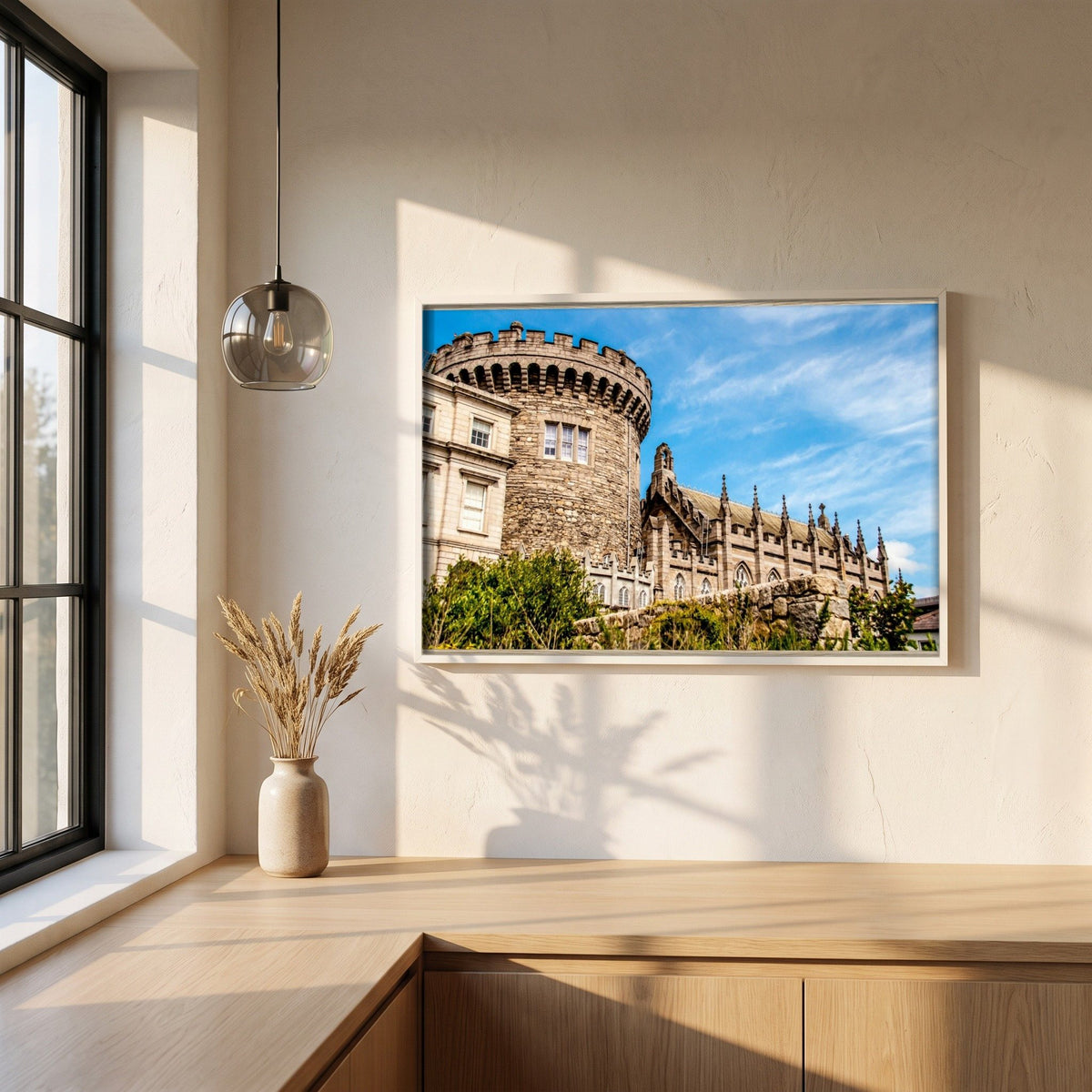 Dublin Castle photographic print in a white frame on a plaster wall above an oak worktop in a bright Scandinavian kitchen