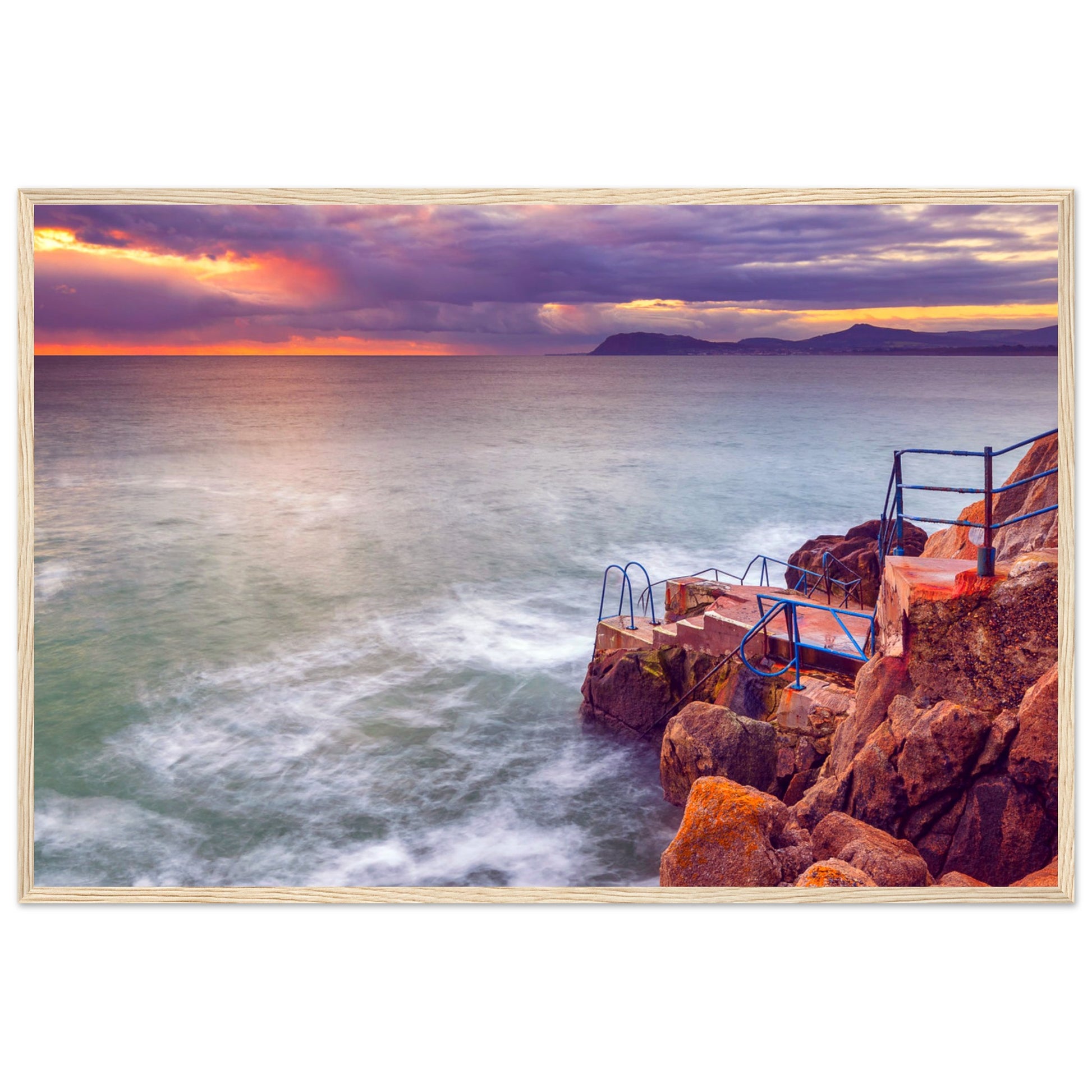 Framed wall art print of Vico Baths in Dalkey, Dublin. Features serene coastal scenery with clear waters and natural rock formations, capturing the iconic outdoor swimming spot. Perfect for adding a touch of Irish coastal beauty to any room.