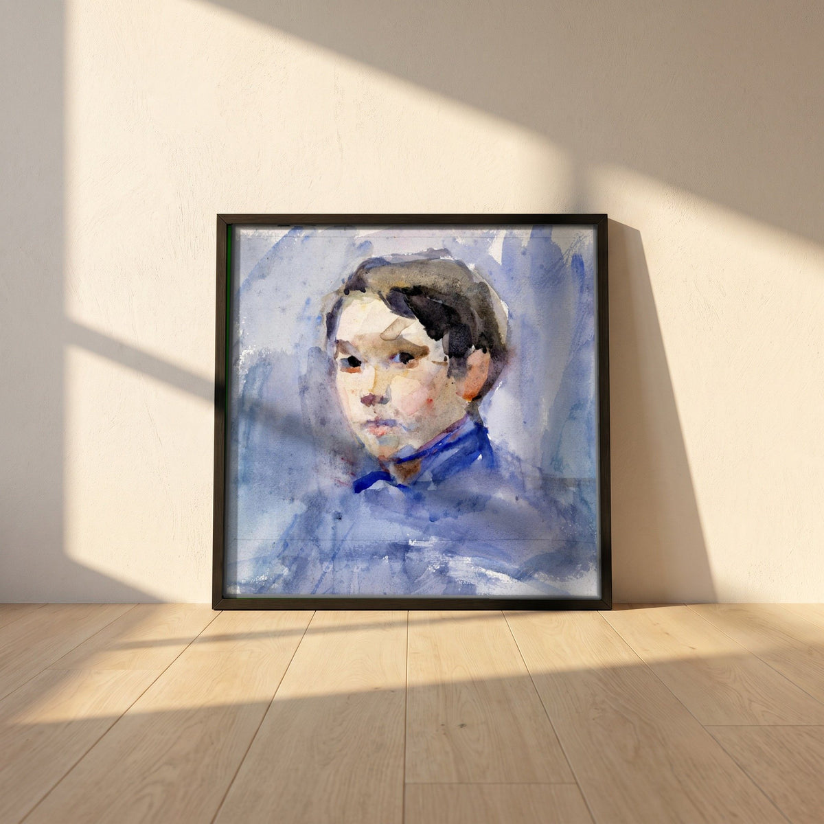 Head of a Young Boy by Clare Marsh framed print in a black frame leaning against a white plaster wall on oak floorboards in morning light