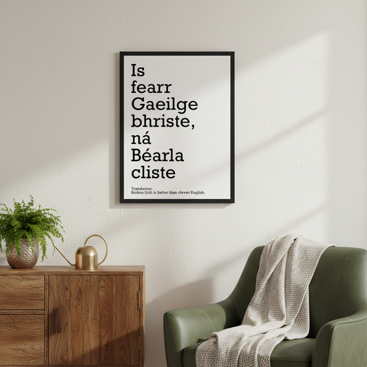 Is fearr Gaeilge bhriste ná Béarla cliste print in a black frame above a sideboard beside a green armchair