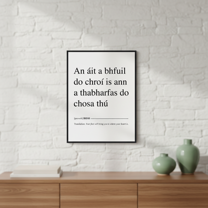 Your Feet Will Bring You Where Your Heart Is Irish proverb print in a black frame on a white brick wall