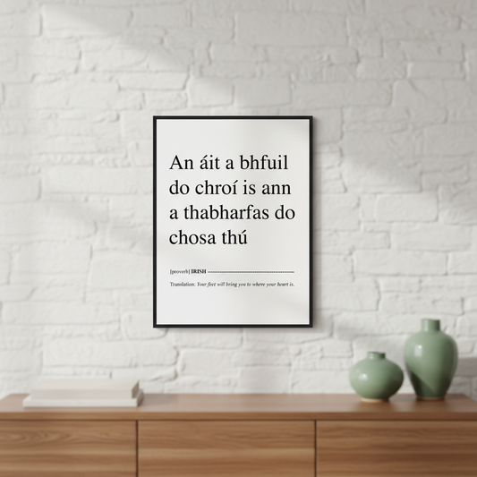 Your Feet Will Bring You Where Your Heart Is Irish proverb print in a black frame on a white brick wall