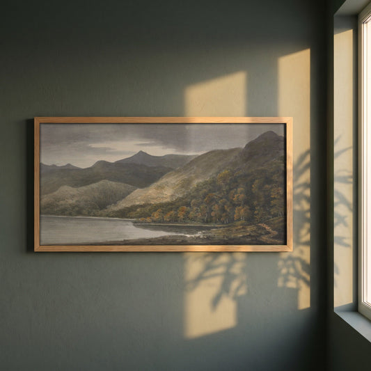 Killarney, Panoramic framed print in a natural oak frame on a dark green wall beside a window, dappled plant shadow