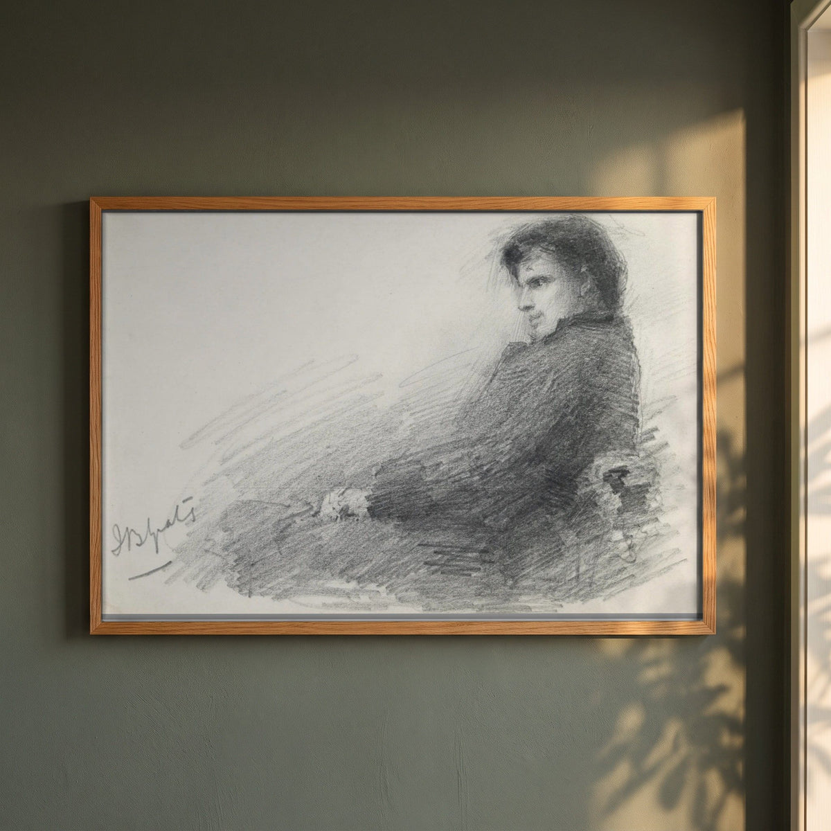 Portrait of a Young W.B. Yeats framed print in a natural oak frame on a dark green wall beside a window, dappled plant shadow
