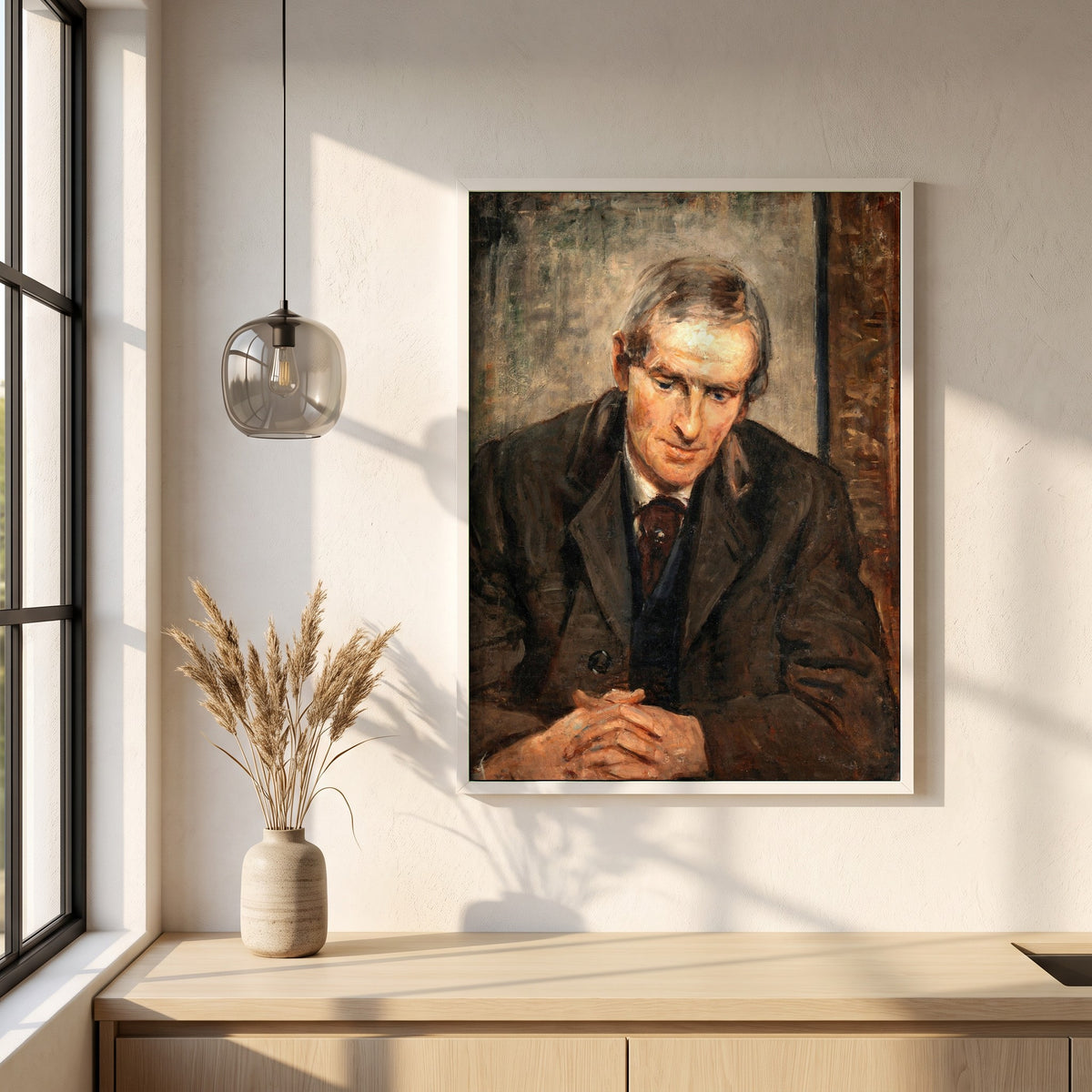 Portrait of Jack B. Yeats framed print in a white frame on a plaster wall above an oak worktop in a bright Scandinavian kitchen