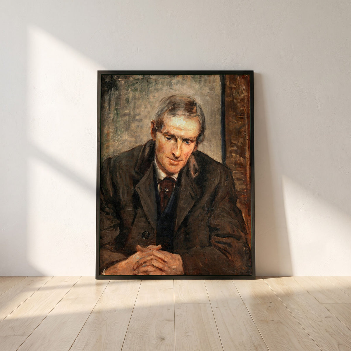 Portrait of Jack B. Yeats framed print in a black frame leaning against a white plaster wall on oak floorboards in morning light