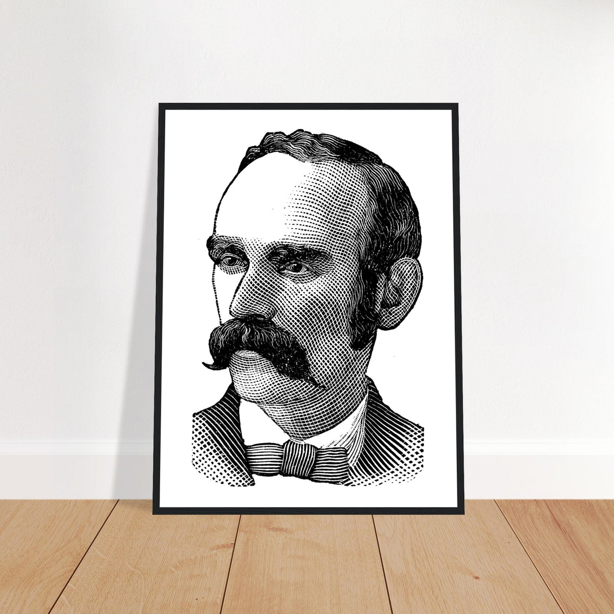 Portrait of Michael Davitt in a black frame leaning against a white wall on a wooden floor