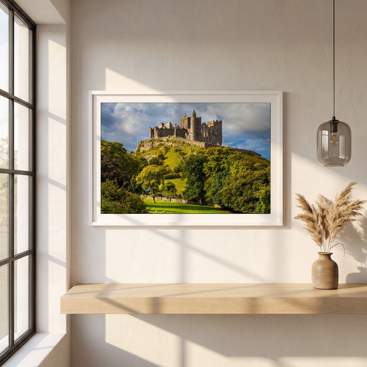 Rock of Cashel framed print in a white frame on a plaster wall above an oak worktop in a bright Scandinavian kitchen