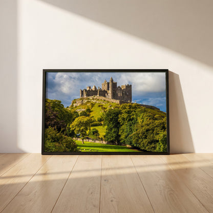 Rock of Cashel framed print in a black frame leaning against a white plaster wall on oak floorboards in morning light