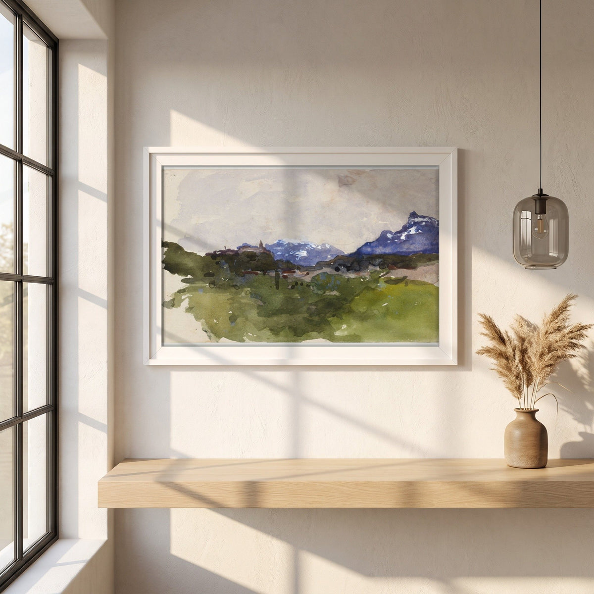 The Pyrenees Mountains framed print in a white frame on a plaster wall above an oak worktop in a bright Scandinavian kitchen