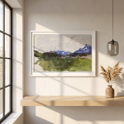 The Pyrenees Mountains framed print in a white frame on a plaster wall above an oak worktop in a bright Scandinavian kitchen